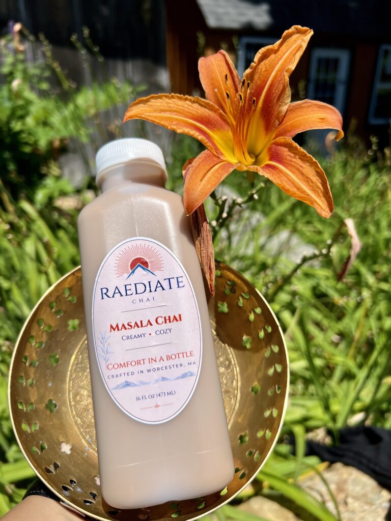Bottled chai beverage in branded bottle with orange accent tiger lily